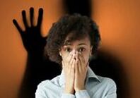 Dark shadow behind woman about to scream creepy short stories